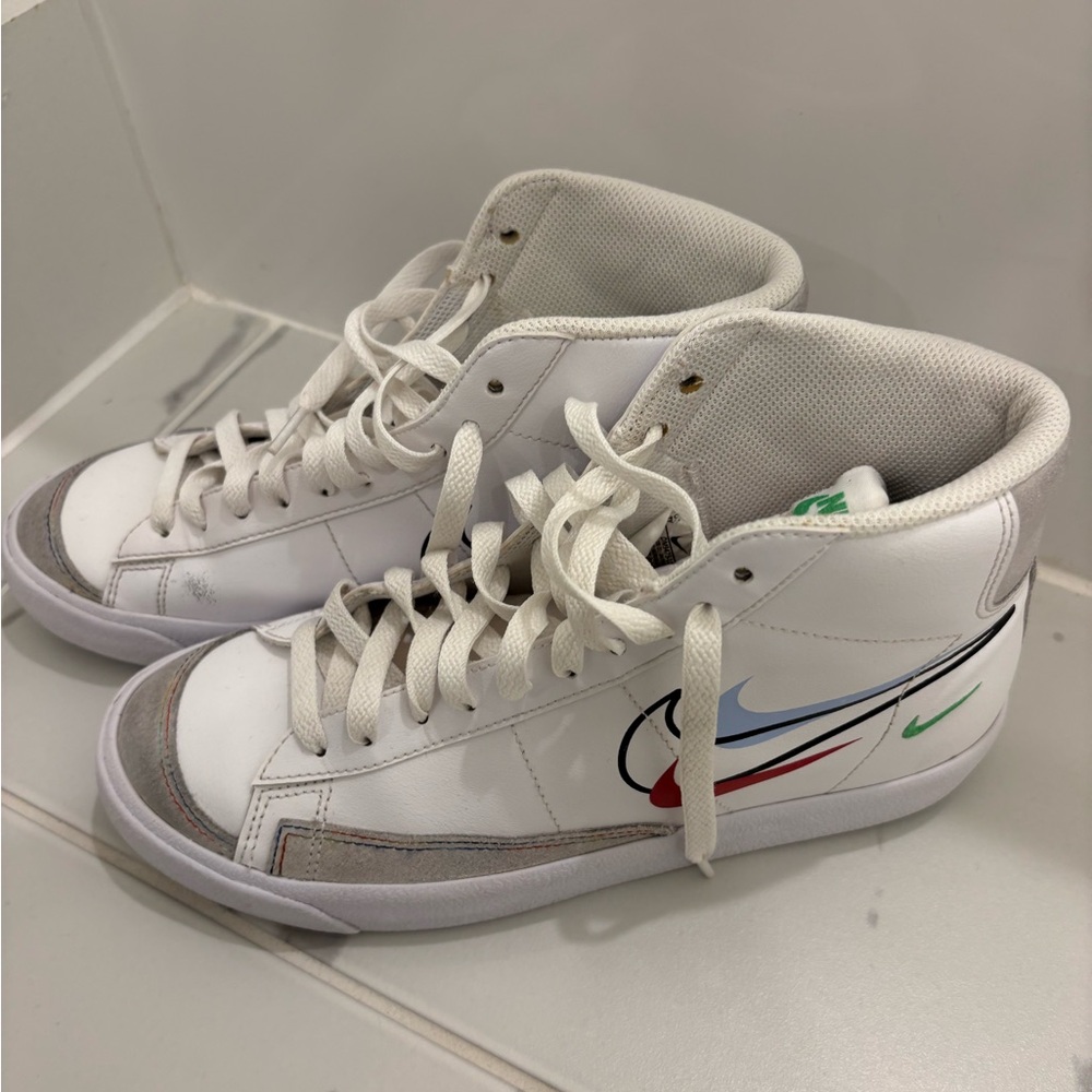 Nike White and Gray High-Tops with Multicolor Swoosh.